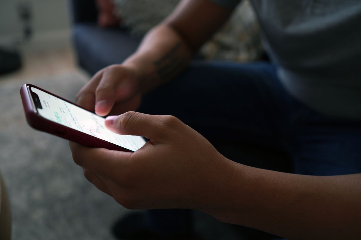 Person checking information on a smartphone at home